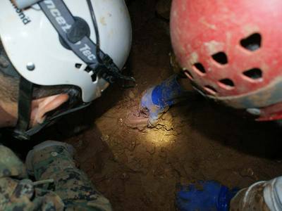 two cavers examining a bone