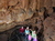 Visitors standing inside cave