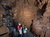 Group of Indiana Cave visitors standing by waterfall