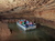 Group of Indiana Cave visitors standing by waterfall