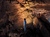 Group of Indiana Cave visitors standing by waterfall