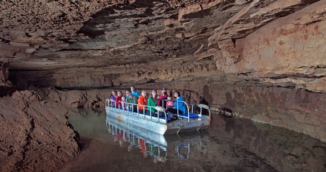 cave visitors in boat