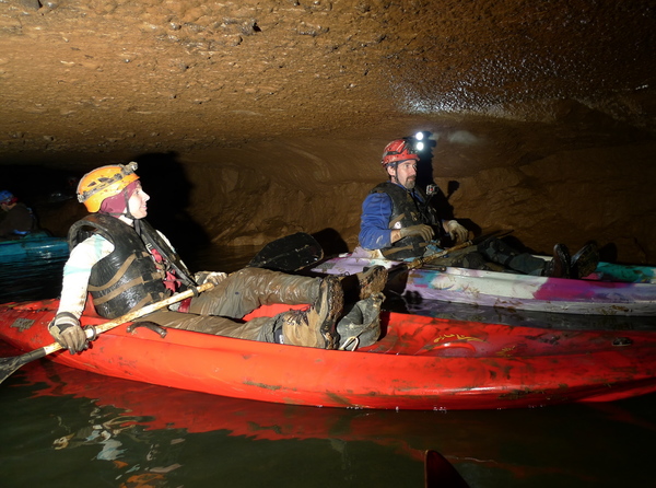 Cave Explorers Kayaking Underground