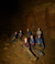 employee belaying exploring as they enter or exit the cave