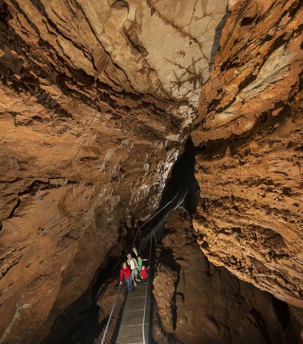 Visitors standing inside cave